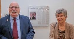 Edward and Valerie Faleski stand in front of a plaque