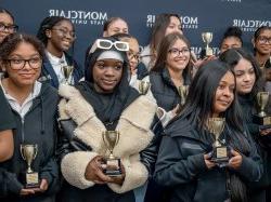 Women leaders holding awards.