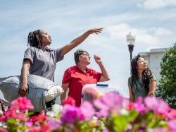 three people outside, one giving directions